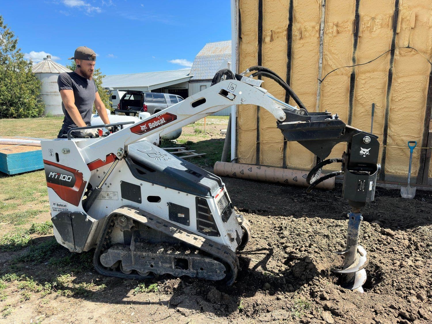 Osborne crew member operating a Bobcat skid-steer on-site